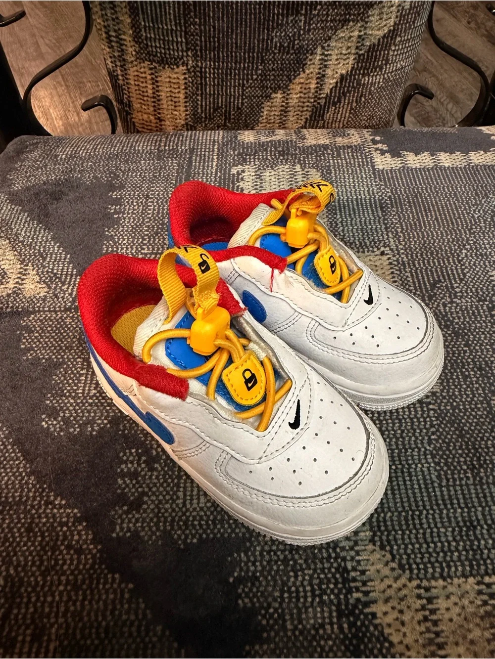 Nike White Kids Sneakers with Red Lining, Yellow Laces & Blue Accents